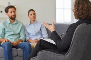 Couple engaged in a therapy session, seeking professional guidance to address relationship challenges, highlighting the benefits of couples therapy for communication and conflict resolution